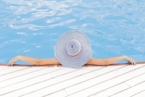 A woman relaxing in the pool side.