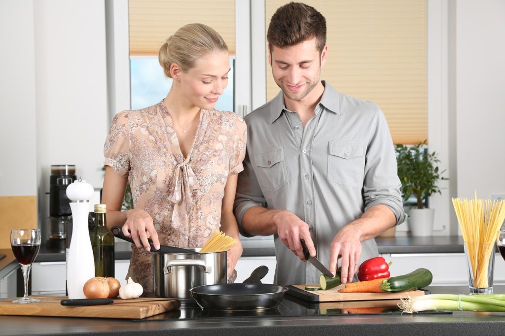 A couple preparing a healthy meal on their kitchen table